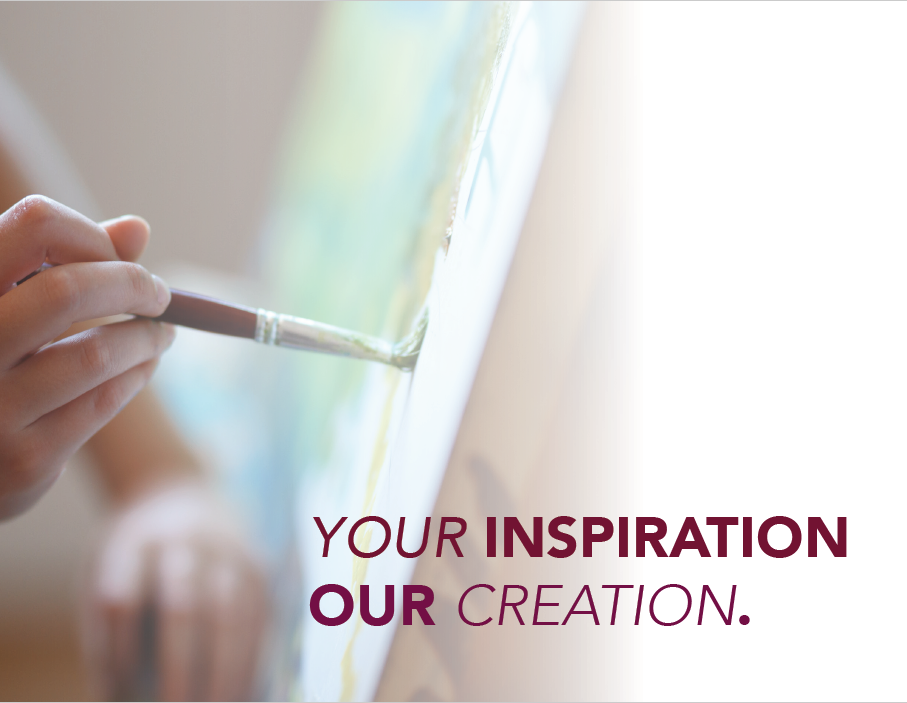 A person holding a paintbrush and painting on the wall.
